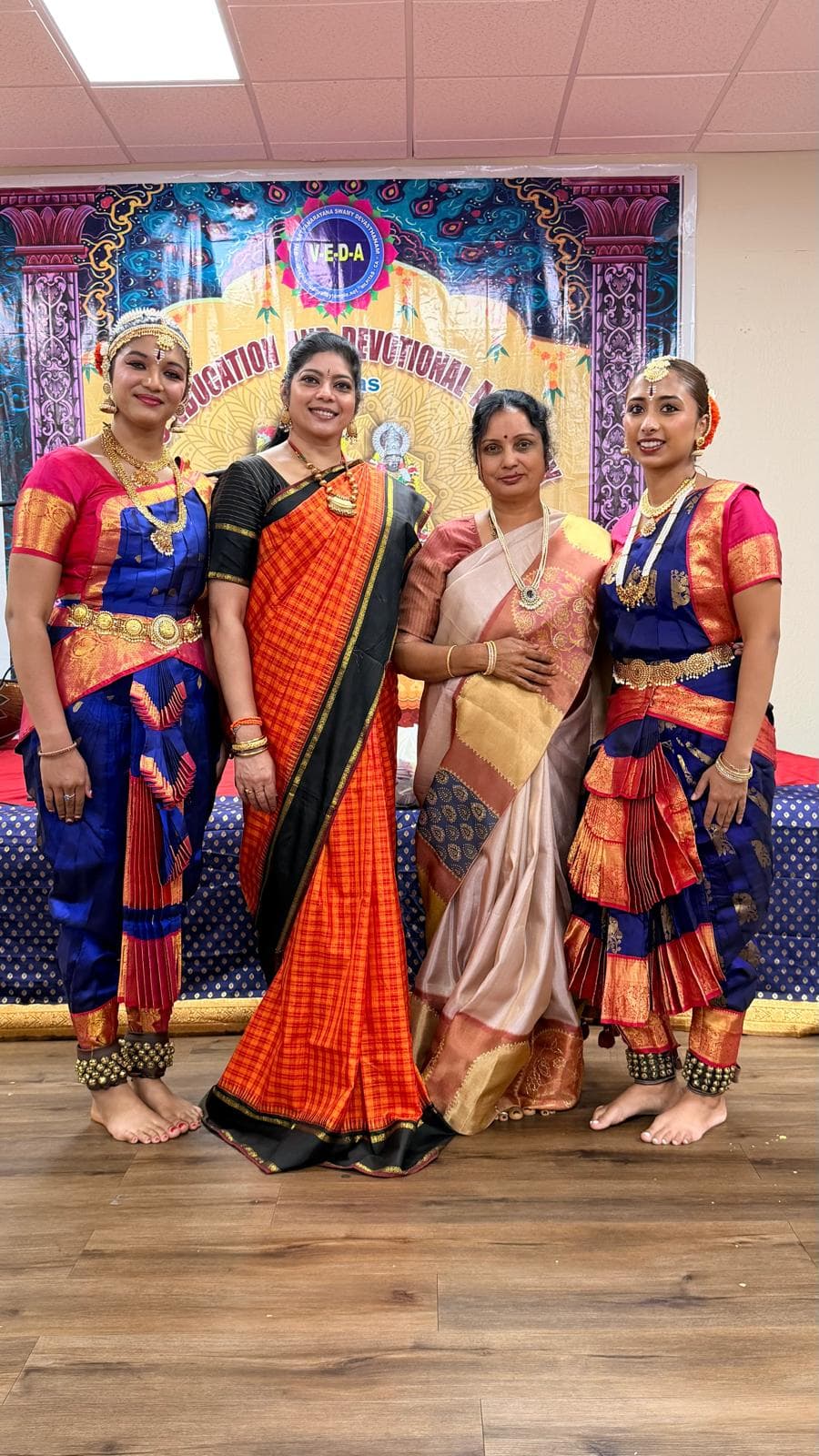 Chandna Talluri with three of her Bharatanatyam students, in full costume and temple jewellery, backstage at a performance.